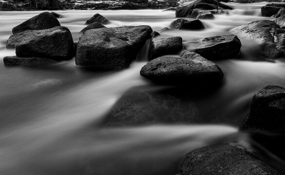 Black and white long exposure of water flowing through rocks, Maine
