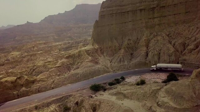 Cinematic Aerial Drone View of Road Passing Trucks Through Buzi Pass, Makran Coastal Highway, Balochistan, Pakistan