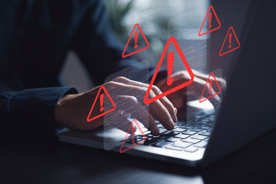 Digital Security Threat: Hands Typing on Laptop with Multiple Red Warning Signs and Code Overlays, Symbolizing Data Breach, System Error, or Cyberattack Risk - Powered by Adobe