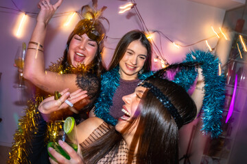 Happy young women enjoying costume home party celebrating new year