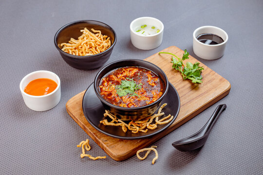 Spicy and flavorful chicken manchow soup prepared with shredded chicken, vegetables, and aromatic Asian spices, topped with crispy fried noodles. A popular Indo-Chinese soup known for its bold taste a