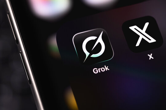 Grok and X mobile icon app on a screen smartphone. Grok is a generative AI-powered chatbot developed by xAI. Batumi, Georgia - November 12, 2025