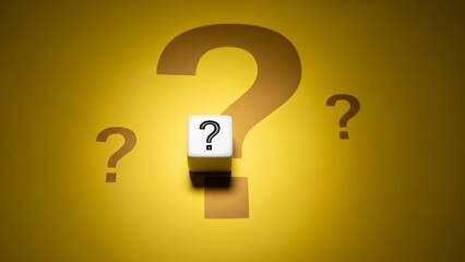 White dice with a black question mark on a bright yellow background with multiple shadow question marks
