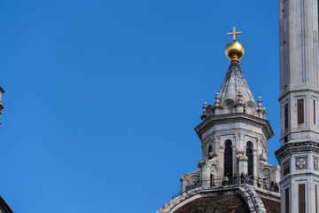 Fototapeta premium Dome and golden cross of Florence Cathedral Duomo. Close-up of the dome and golden cross of the Florence Cathedral (Duomo di Firenze), a masterpiece of Renaissance architecture in Italy