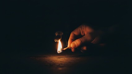 Hand Lighting Match in Dark Environment.