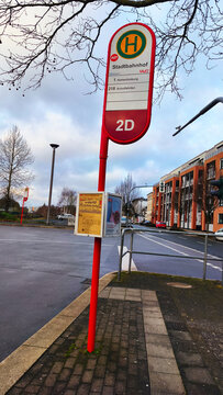 ISERLOHN, GERMANY &mdash; DECEMBER 11 2025: MVG bus stop at Iserlohn railway station with people waiting and urban winter scene