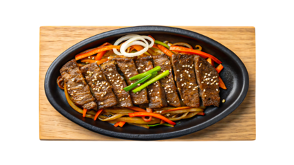 Grilled beef slices served with vegetables on black plate
