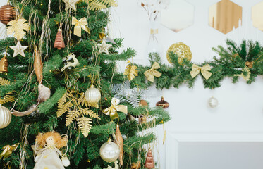 Holiday background. Christmas tree in white interior. Decorated Christmas tree close up. Christmas decorations. Light Holiday wallpaper.