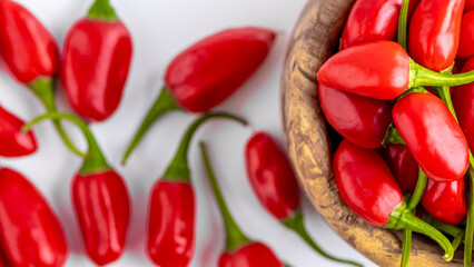 Vibrant red jalapeno pepper on a white background with space for text, ideal for food and culinary concepts.Group of ripe red jalapeno peppers .