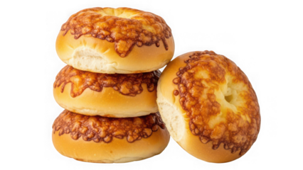 Stack of three cheese bagels with one leaning against the side isolated on transparent background