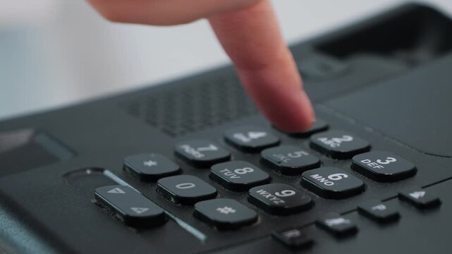 Hotel guest pick up the telephone and dial the room service number. Hotel telephone service concept. High quality 4k footage