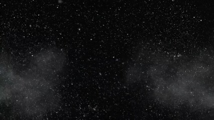 Abstract dark background displays fine white particles swirling across the frame suggesting heavy snowfall or atmospheric dust ideal for winter overlays and dramatic visual effects.