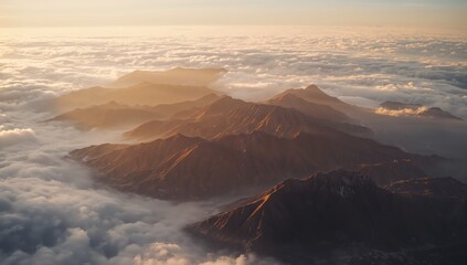 Scenic Flight View Over Cloud Inversion and Rugged Mountain Summits Bathed in Warm Sunlight Glow