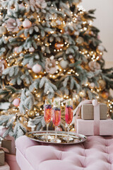 Festive Cocktails by Christmas Tree with Gifts