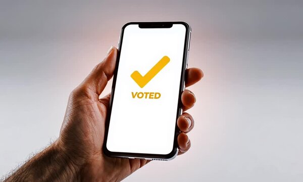 Hand Holding Smartphone Displaying 'VOTED' with Checkmark for Online Election