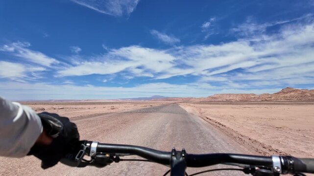 San Pedro de Atacama, Chile: Point of view footage of cycling on the road of San Pedro de Atacama desert toward the moon valley in Chile on sunny day