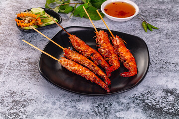 Grilled prawn skewer served sauce
