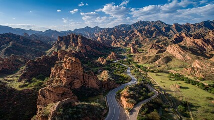 Red rock canyon landscape with winding road and river under a blue sky