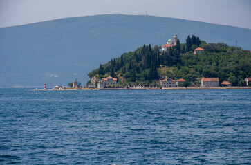 Fototapeta premium Coastal Island Village with Lighthouse and Hills