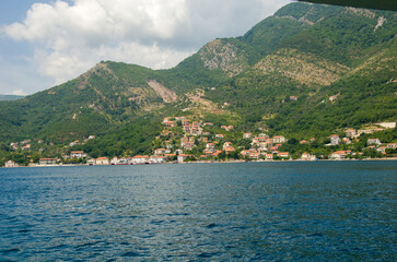 Fototapeta premium Coastal Village Surrounded by Mountains