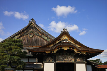Kyoto,Nijo. Historic Japanese Temple Gate With Visitors In Courtyard Under A Bright Blue Sky