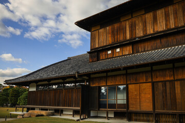 Fototapeta premium Kyoto,Nijo. Traditional Japanese Wooden Building With Tiled Roof And Sliding Doors In Calm Garden Scene
