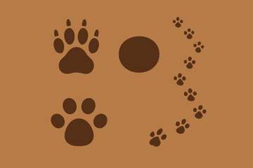 Obraz premium Brown dog paw prints and a circular mark on a brown background