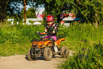 Fototapeta premium Girl riding an electric quad bike