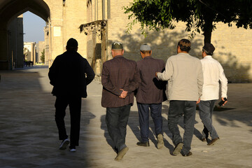 Group of men walking in Bukhara, Uzbekistan