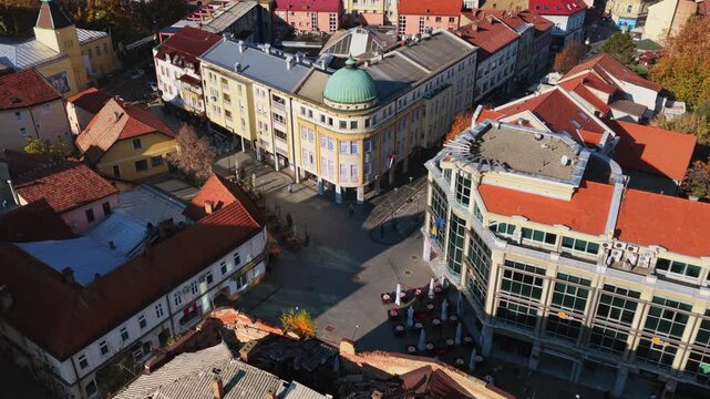 Aerial drone view of Trg Slobode, Tuzla's largest city square, featuring its central fountain, open plaza, surrounding cafes, and historic facades. Bosnia and Herzegovina