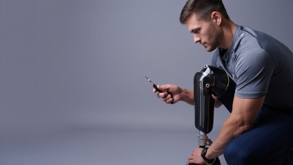 amputee adjusting knee prosthesis while checking fit using smartphone