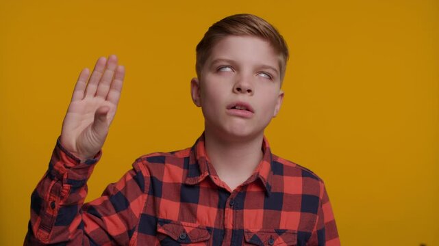 Boy Makes a 'Bla Bla' Gesture with his Hand near his Face, Expressing Boredom or Sarcasm
