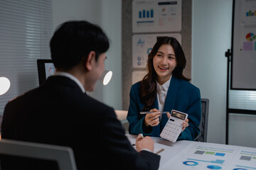 Financial advisor discussing investment calculations with client in office