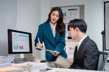 Business colleagues collaborating on data analysis in office