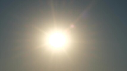 A bright sun shining in a clear blue sky, radiating warmth and positivity over a peaceful nature landscape, symbolizing hope, energy, and the beauty of a new day, fa01