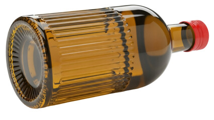 Isolated amber glass bottle with ribbed design, red cap, vintage look, lying down, clear contents