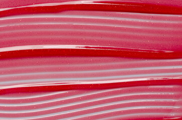 Lip oil, liquid red lipstick. Cosmetic product for lip moisturizing.