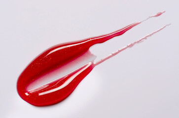 A sample of lip moisturizer on a white background. Oil or lip balm.