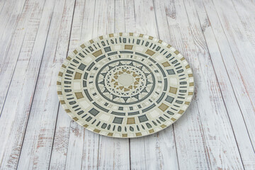Obraz premium A polychrome porcelain plate on a white table