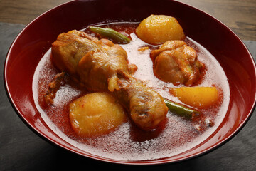 Bengali style spicy chicken curry stew with potato leg piece recipe ingredients tomato ginger gallic onion cumin coriander garam masala salt turmeric chili