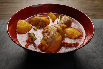 Bengali style spicy chicken curry stew with potato leg piece recipe ingredients tomato ginger gallic onion cumin coriander garam masala salt turmeric chili