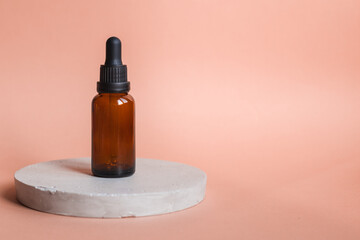 Different serum cosmetic bottles, white and dark brown dropper bottle container and packaging skincare product. studio pastel light background.