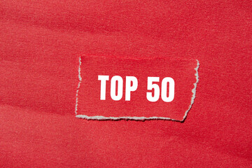 Top 50 message written on ripped torn paper background. Conceptual Top 50 symbol. Copy space.