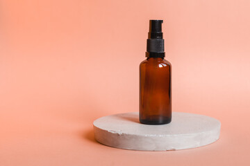 Different serum cosmetic bottles, white and dark brown dropper bottle container and packaging skincare product. studio pastel light background.