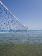 Volleyball net against a blue sky