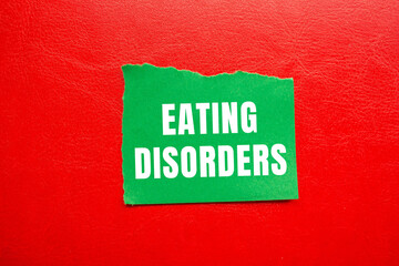 Eating Disorders message written on ripped torn paper background. Conceptual Eating Disorders symbol. Copy space.