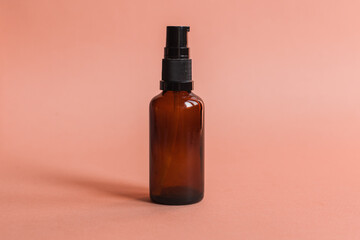 Different serum cosmetic bottles, white and dark brown dropper bottle container and packaging skincare product. studio pastel light background.