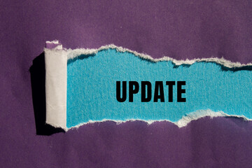 Update message written on ripped torn paper background. Conceptual Update symbol. Copy space.