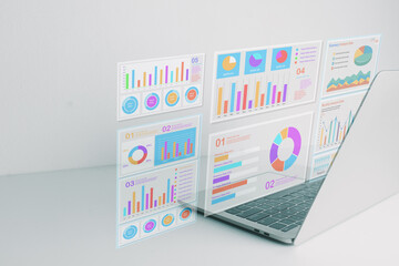 Laptop screen displaying holographic business charts and financial data graphs. Concept of digital marketing analysis, economic growth strategy, corporate report, and statistical presentation.