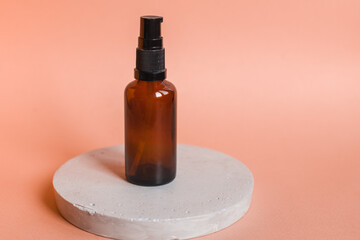 Different serum cosmetic bottles, white and dark brown dropper bottle container and packaging skincare product. studio pastel light background.